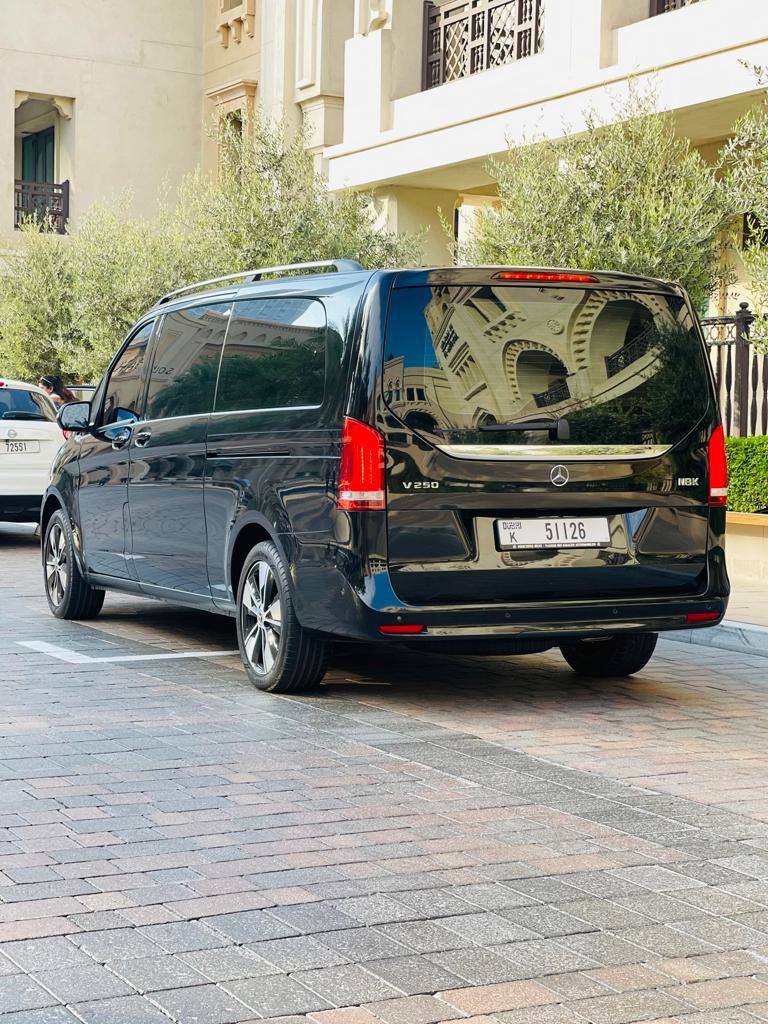 Black minivan parked on the roadside, Car hire with driver in Dubai